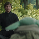 On a lovely forest planet, Luke Skywalker sits with closed eyes and meditates by baby Grogu watches.